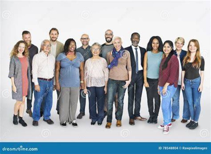 a group of people standing next to each other in front of a wood