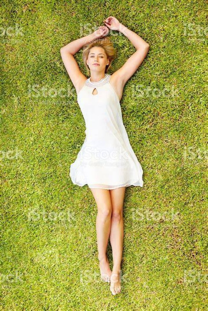 a woman laying on top of a white bed