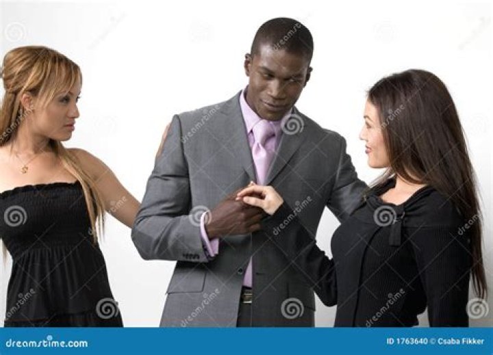 two women and a man posing for the camera
